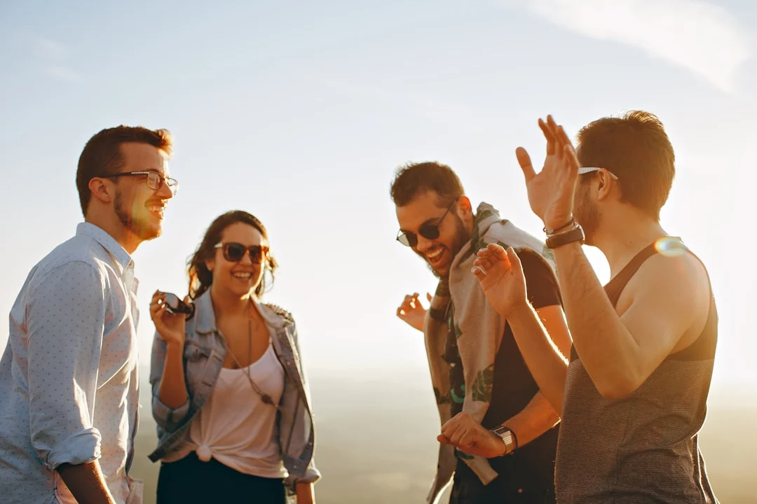 Laughing friends dancing to music near residential detox Peak State Recovery