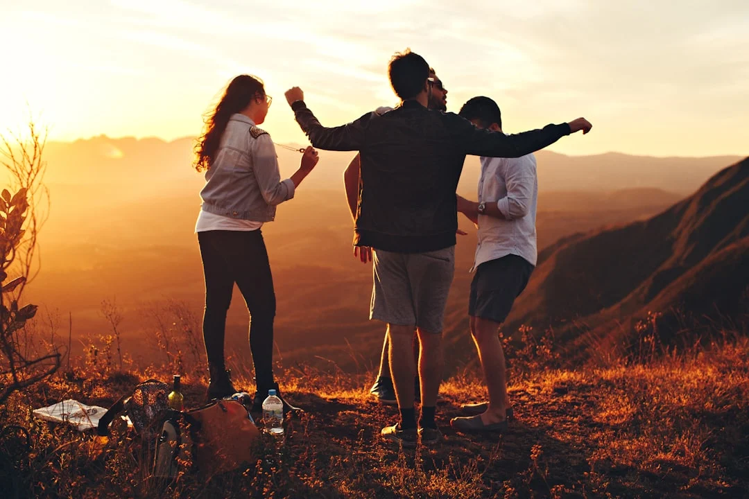 Friends hanging out on a hill, enjoying the view and vibes near residential detox Peak State Recovery