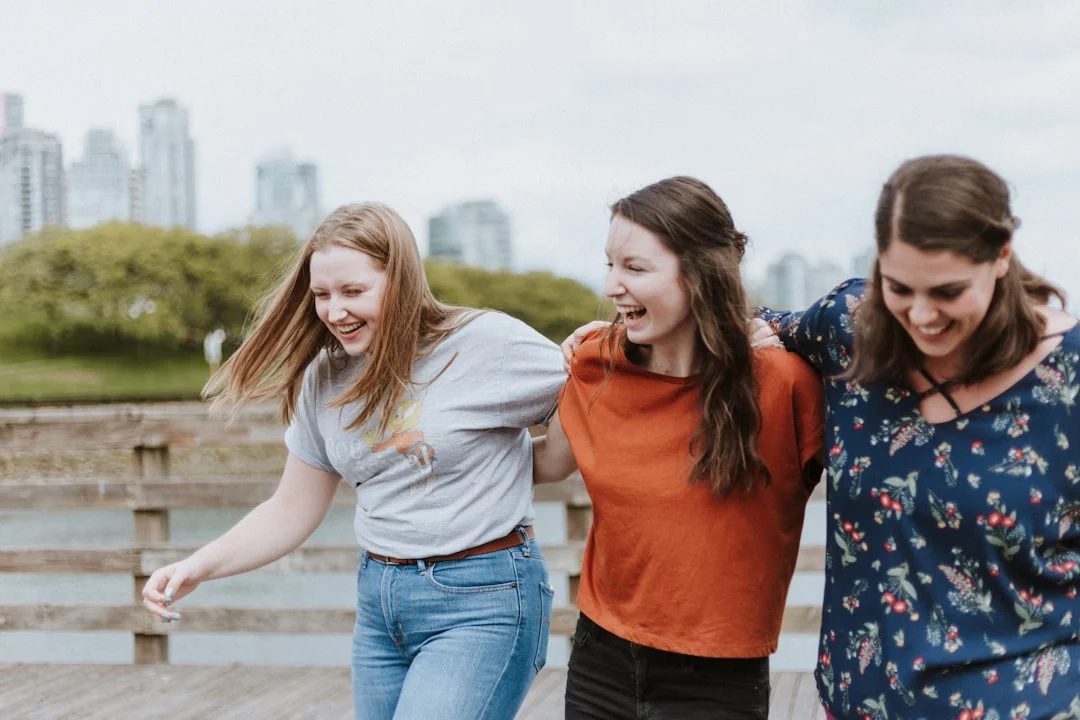 Carefree girls laughing and enjoying the day on the boardwalk near residential detox Peak State Recovery